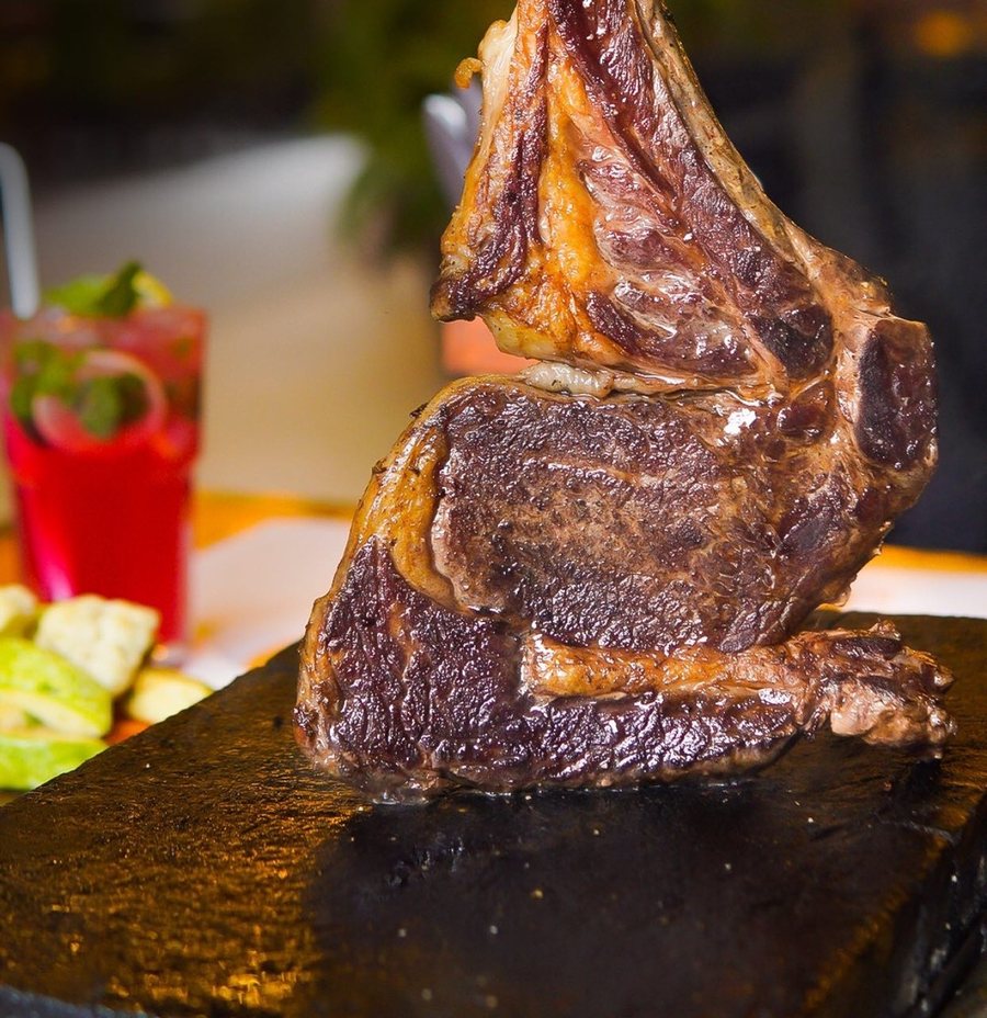 Bone-in Angus ribeye served on a hot stone